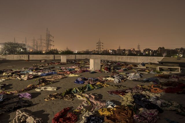 The discarded garments of Covid-19 fatalities on the rooftop of a crematorium in New Delhi, India, on Friday, April 30, 2021. India is suffering the world's worst Covid-19 outbreak, with a daily infection rate surpassing 400,000 and more than 3,000 deaths every day.