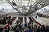 Travelers pass through security at JFK airport.
