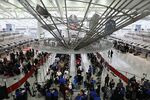 Travelers pass through security at JFK airport.
