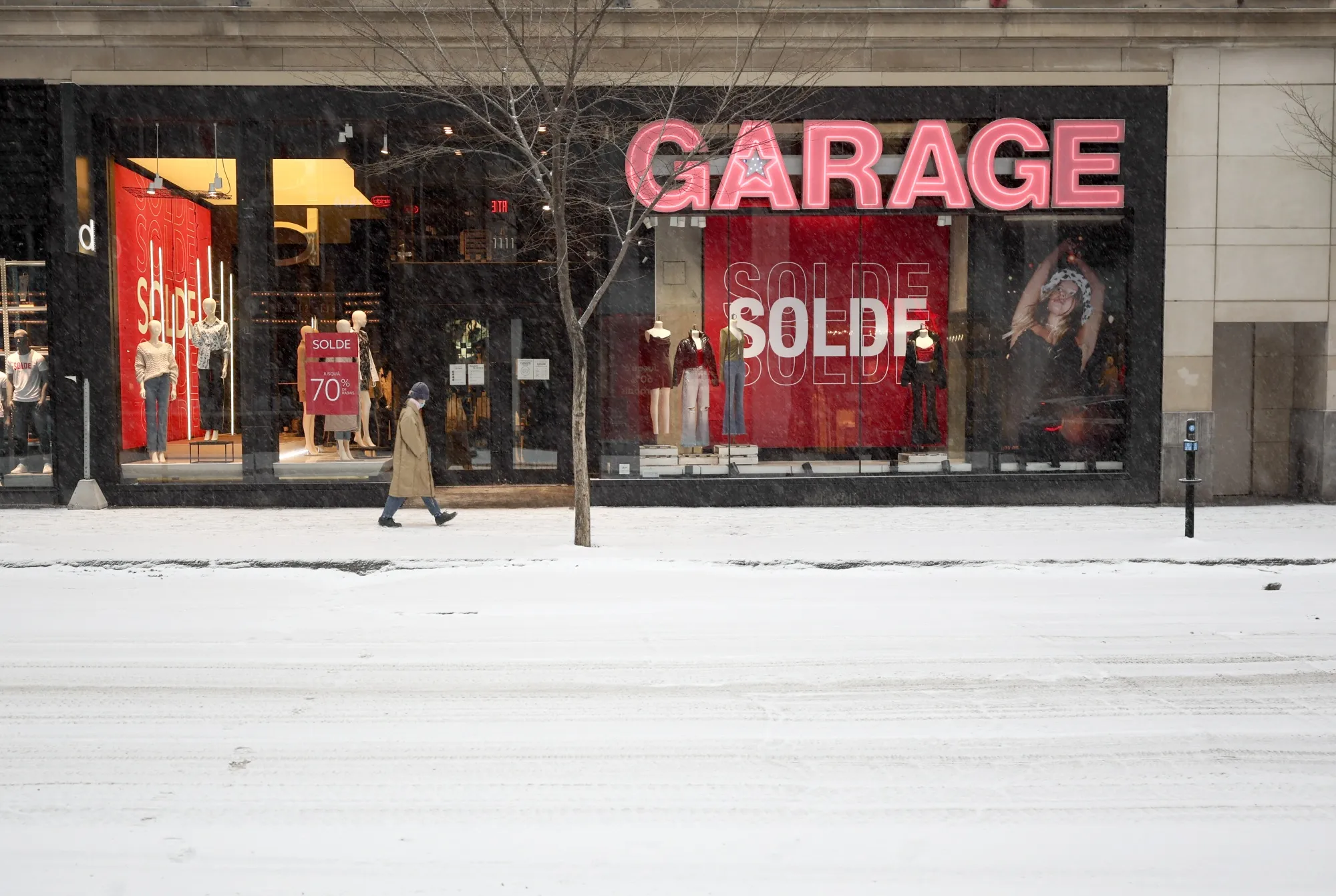 A pedestrian walks past a closed Garage store in Montreal in 2022.&nbsp;