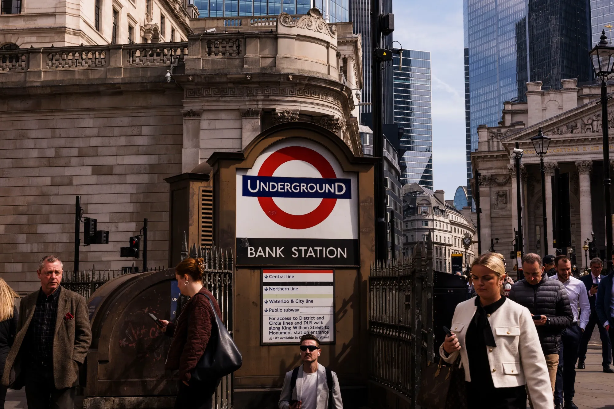 Workers pass Bank London Underground station in the City of London.
