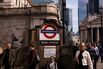 Workers pass Bank London Underground station in the City of London.