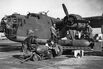 American ground crew priming and loading 1000-pound bombs into a B-24 Liberator bomber, 1943.&nbsp;
