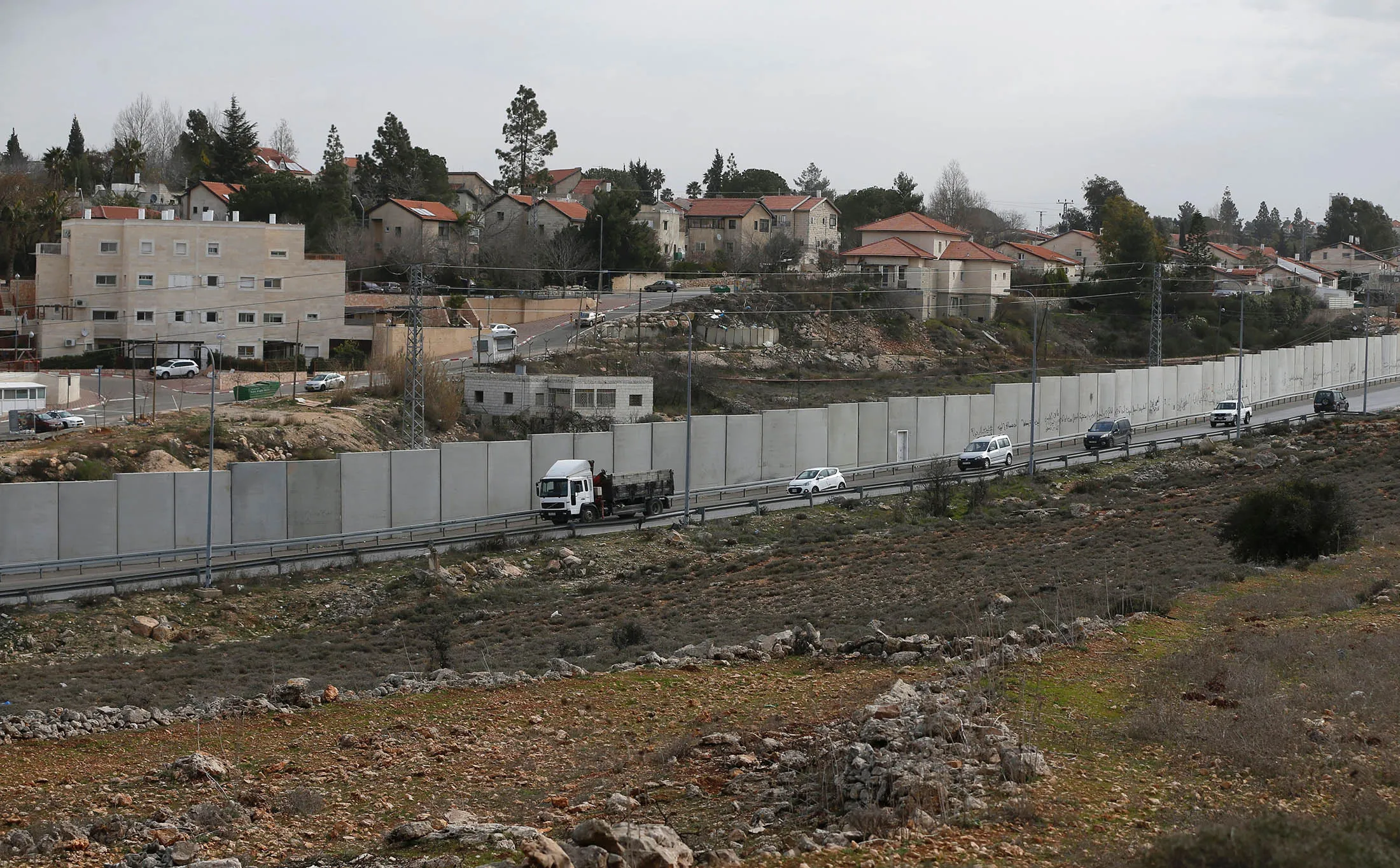 A picture taken from the West Bank city of Ramallah shows Israel's separation barrier and the settlement of Beit El behind it.