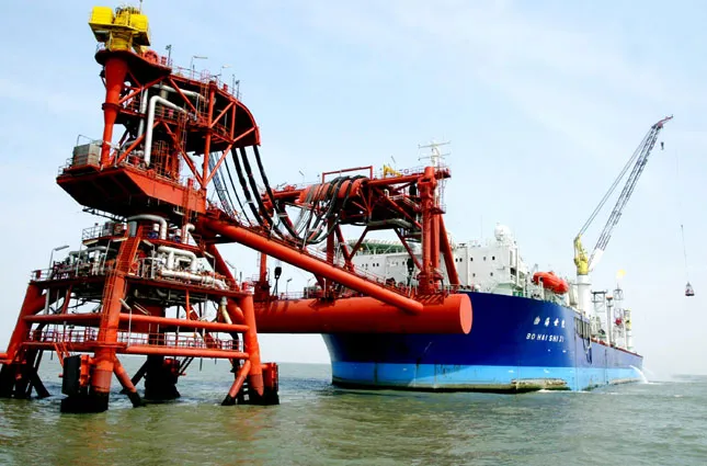 A rig and vessel in the Bohai Sea, now the biggest oil field in China. Photo: China Photos/Getty Images