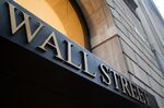 A "Wall Street" sign on a building near the New York Stock Exchange.
