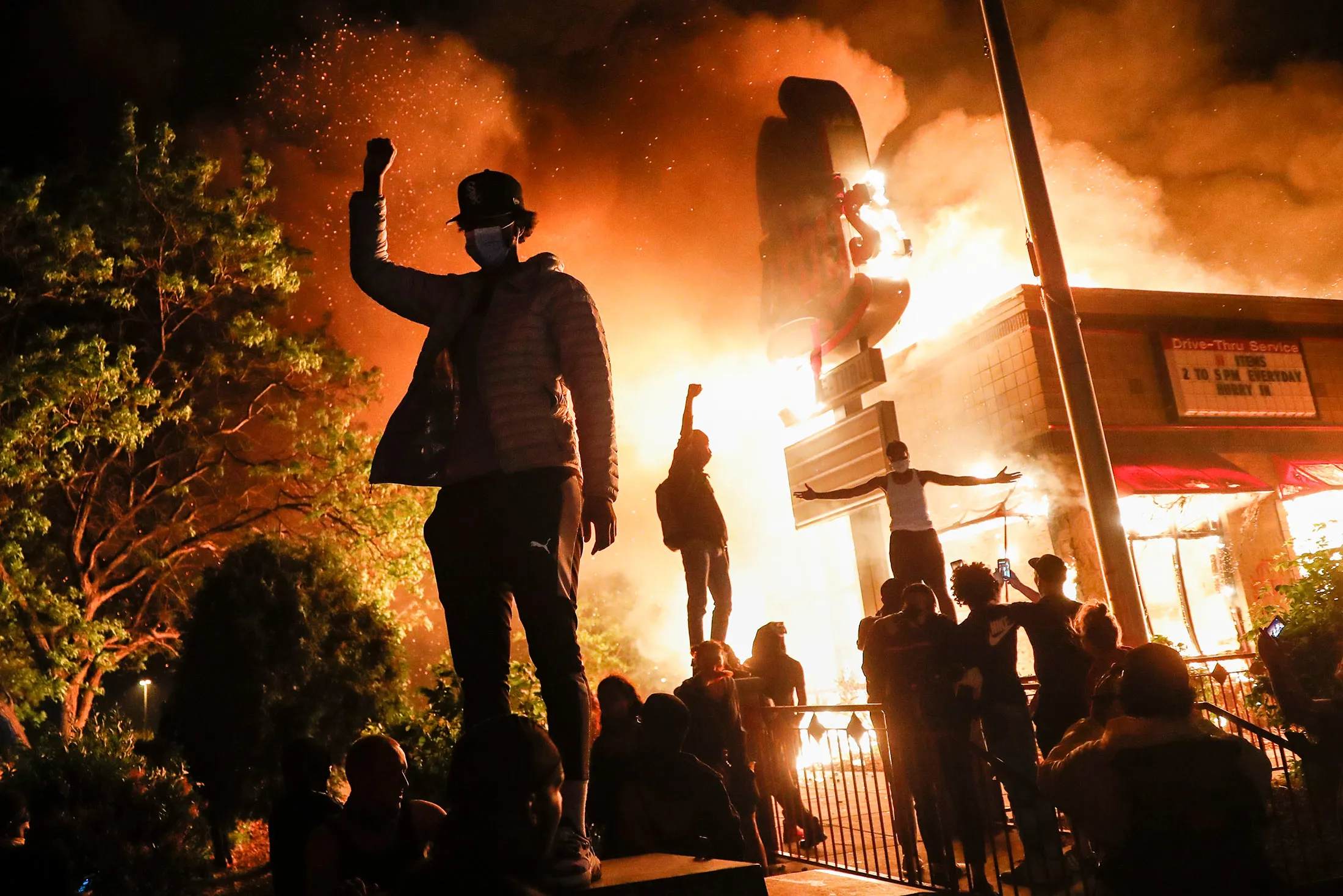 Protestors demonstrate outside of a burning fast food restaurant&nbsp;in Minneapolis on May 29.