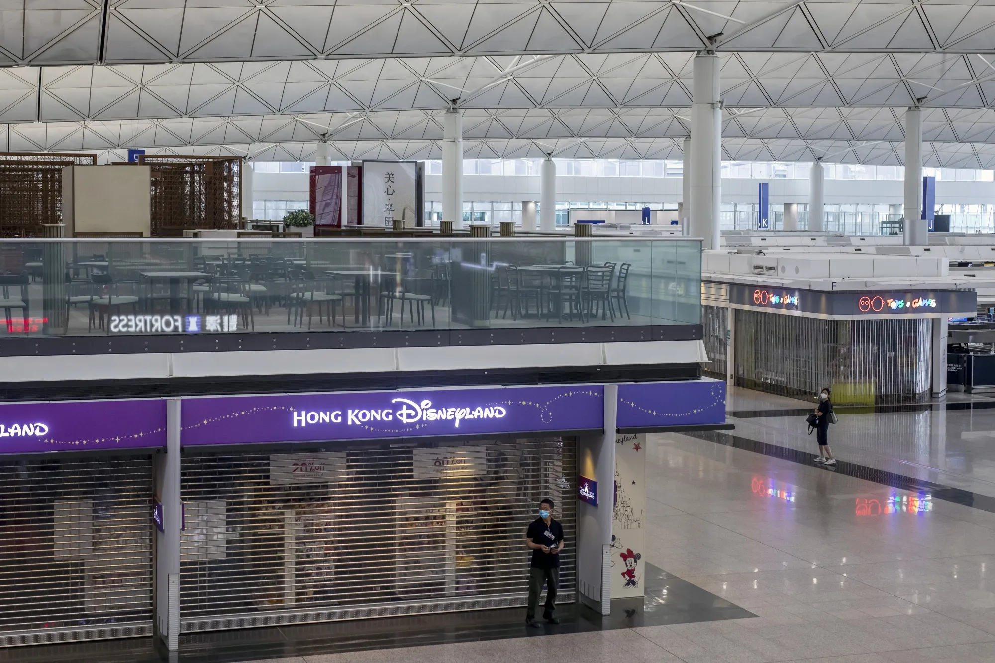 Stores are closed in the deserted departures hall at Hong Kong International Airport in 2021. 