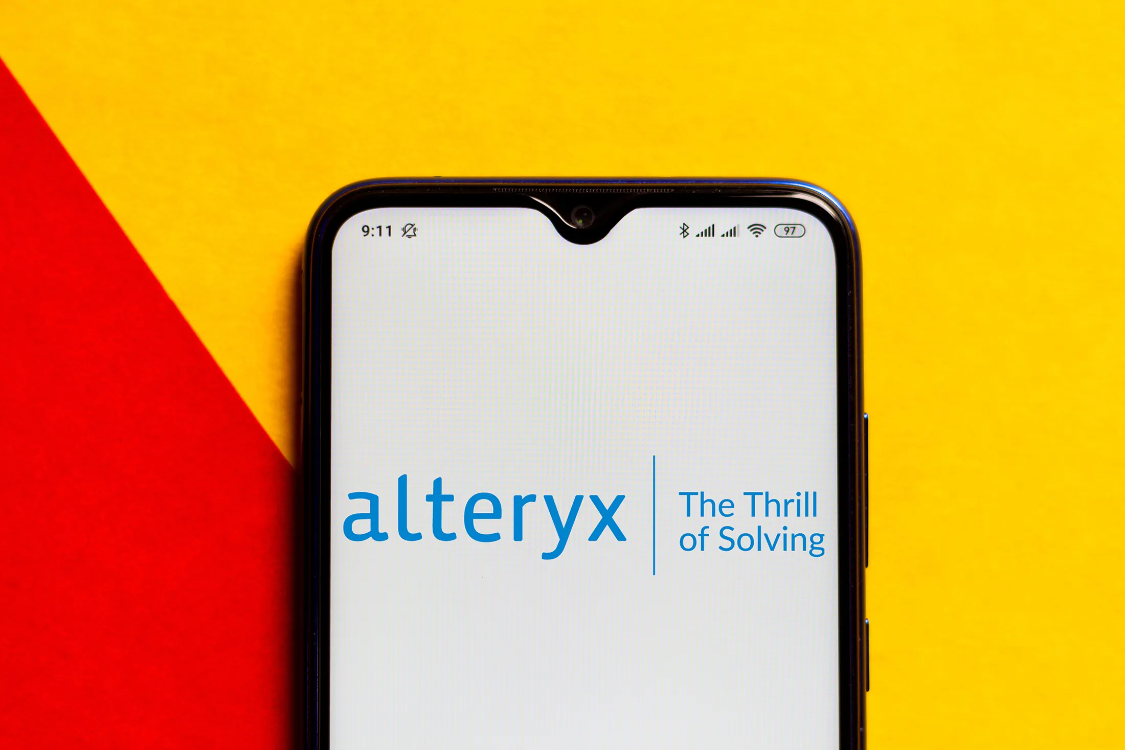 In this photo illustration the Alteryx logo seen displayed