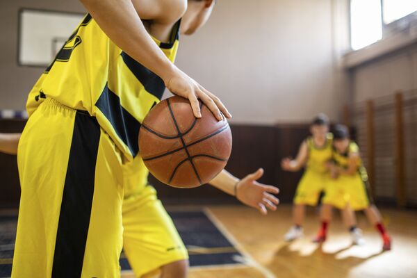 Teenage basketball team plating friendly match at indoors basketball court