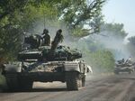 Ukrainian troop move by tanks on a road of the eastern Ukrainian region of Donbas.