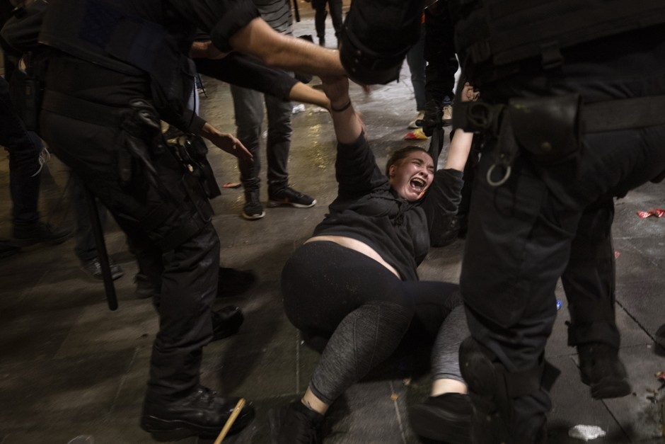 Police officers clash with demonstrators outside El Prat airport in Barcelona, Spain, on Monday, October 14, 2019.