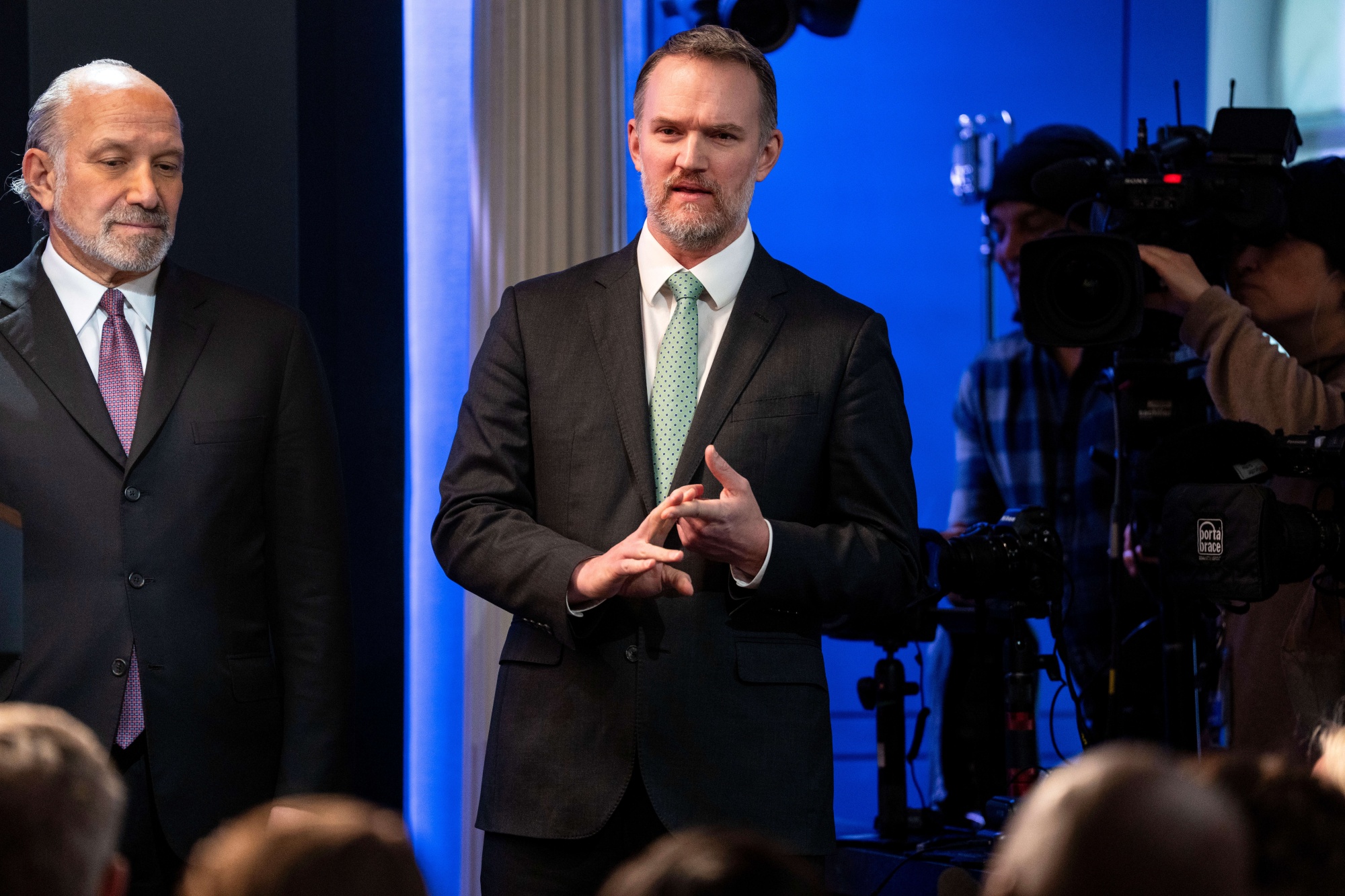Jamieson Greer, US trade representative, center, and Howard Lutnick, US commerce secretary, left, during a news conference in the James S. Brady Press Briefing Room of the White House in Washington, DC, US, on Friday, Feb. 20, 2026. President Donald Trump delivered a broadside against Supreme Court justices after they struck down the bulk of his sweeping global tariffs, delivering a major blow against his signature economic policy.