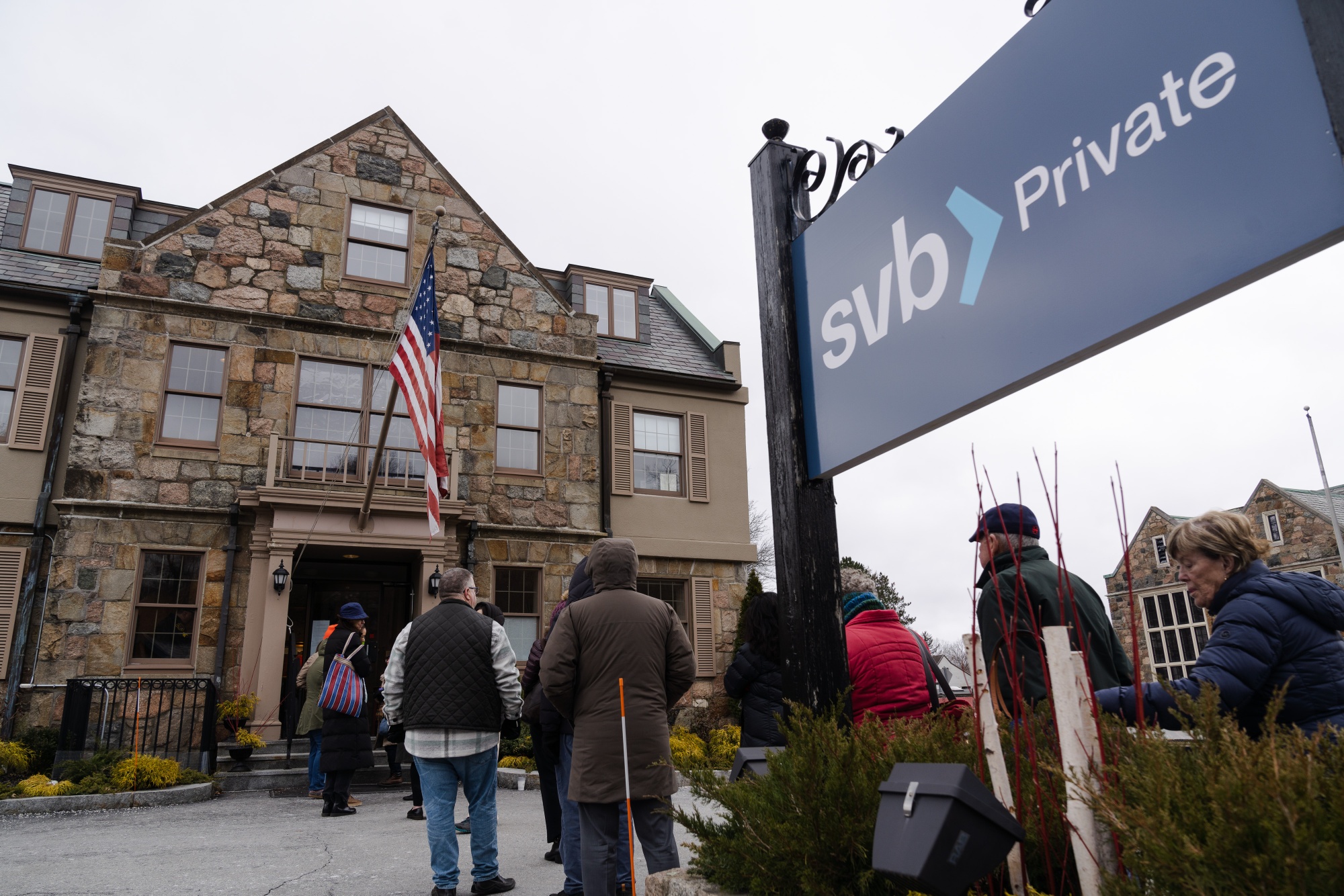 Customers wait in line outside of a Silicon Valley Bank branch in Wellesley, Mass., on&nbsp;March 13.&nbsp;