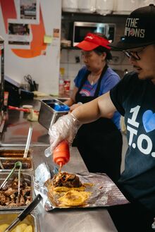 A chef prepares an order at Tropical Joe’s in Leslieville.