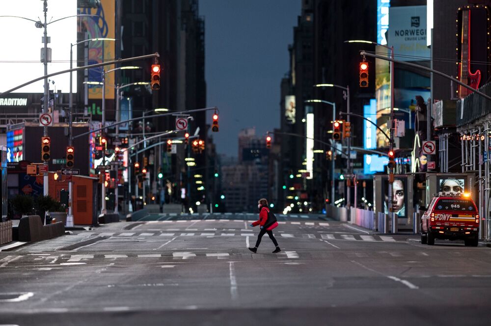 A woman walks through an almost-deserted Times Square in the early morning hours on April 23, 2020 in New York City. 