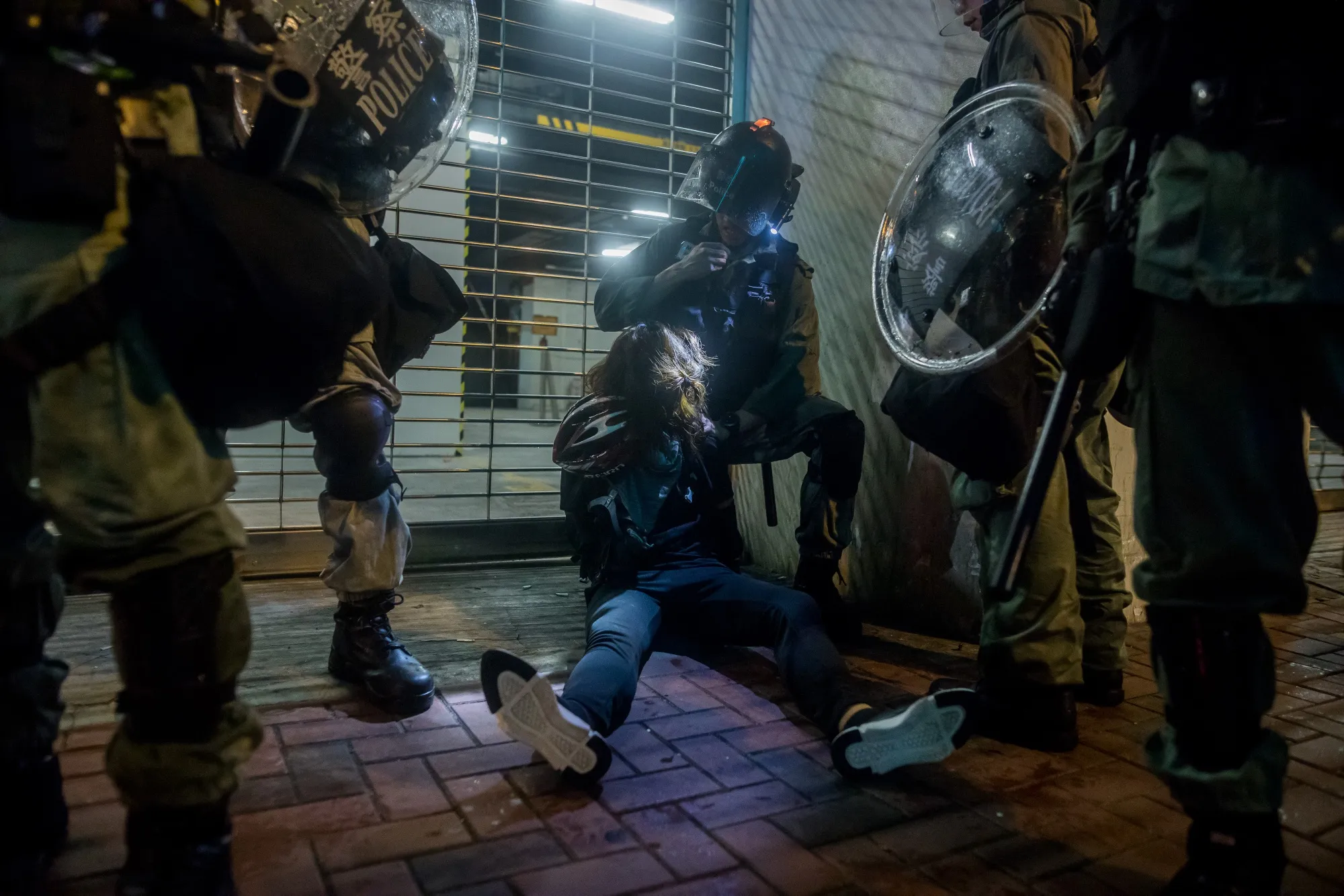 Riot police detain a demonstrator after a clash&nbsp;in the Tsuen Wan district of Hong Kong, Aug. 25.