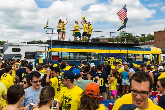 University of Michigan MBAs gather around 'The Bus' before a football game
