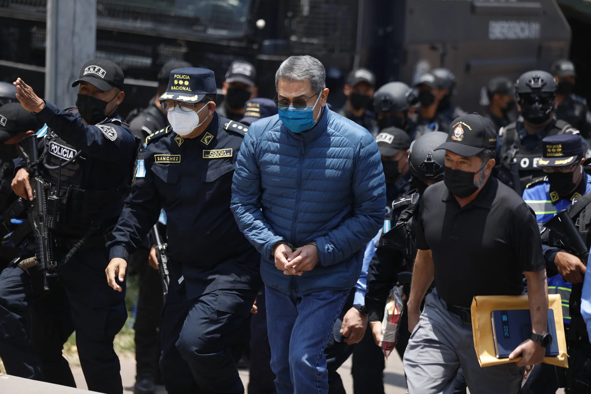 Honduran police officers escort Juan Orlando Hernandez to Toncontin International Airport in Tegucigalpa, Honduras, for extradition in 2022.