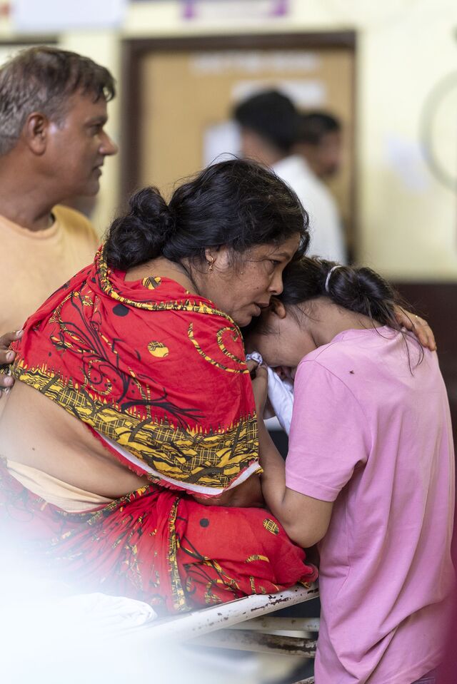 A woman and her daughter share a moment in the emergency ward at ANMMCH