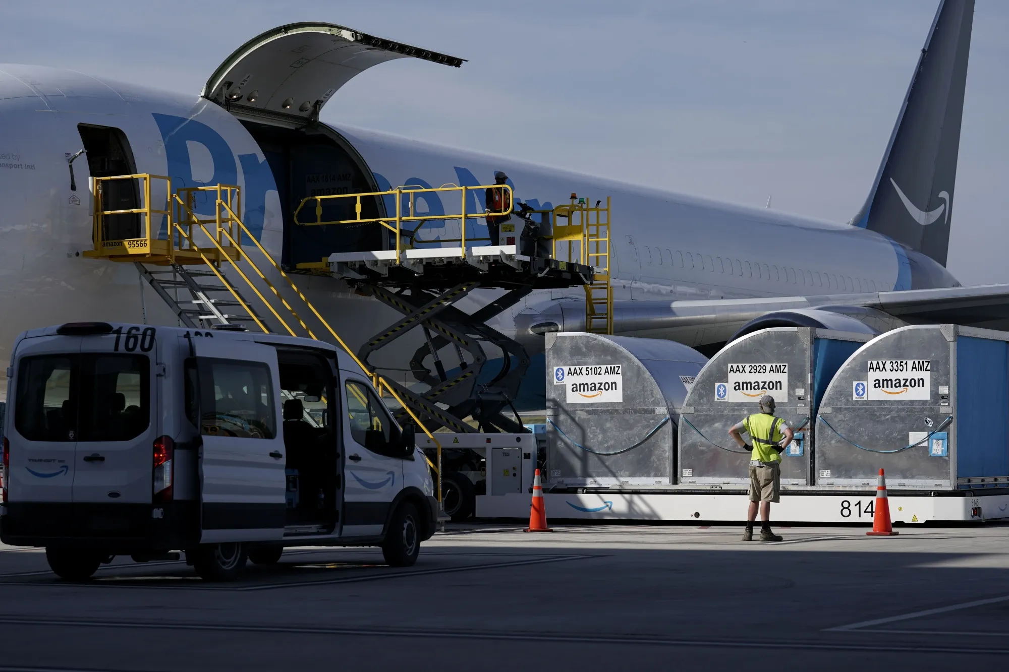 Grounds crew members load cargo into an Amazon Prime Air aircraft at the company's Air Hub at the Cincinnati/Northern Kentucky International Airport (CVG) in Hebron, Kentucky, U.S., on Monday, Oct. 11, 2021. Tech shares outperformed after a report showing a faster-than-expected increase in consumer prices last month lifted companies best able to handle those price pressures. Giants Microsoft Corp. and Amazon.com Inc. led gains in the tech-heavy Nasdaq 100,