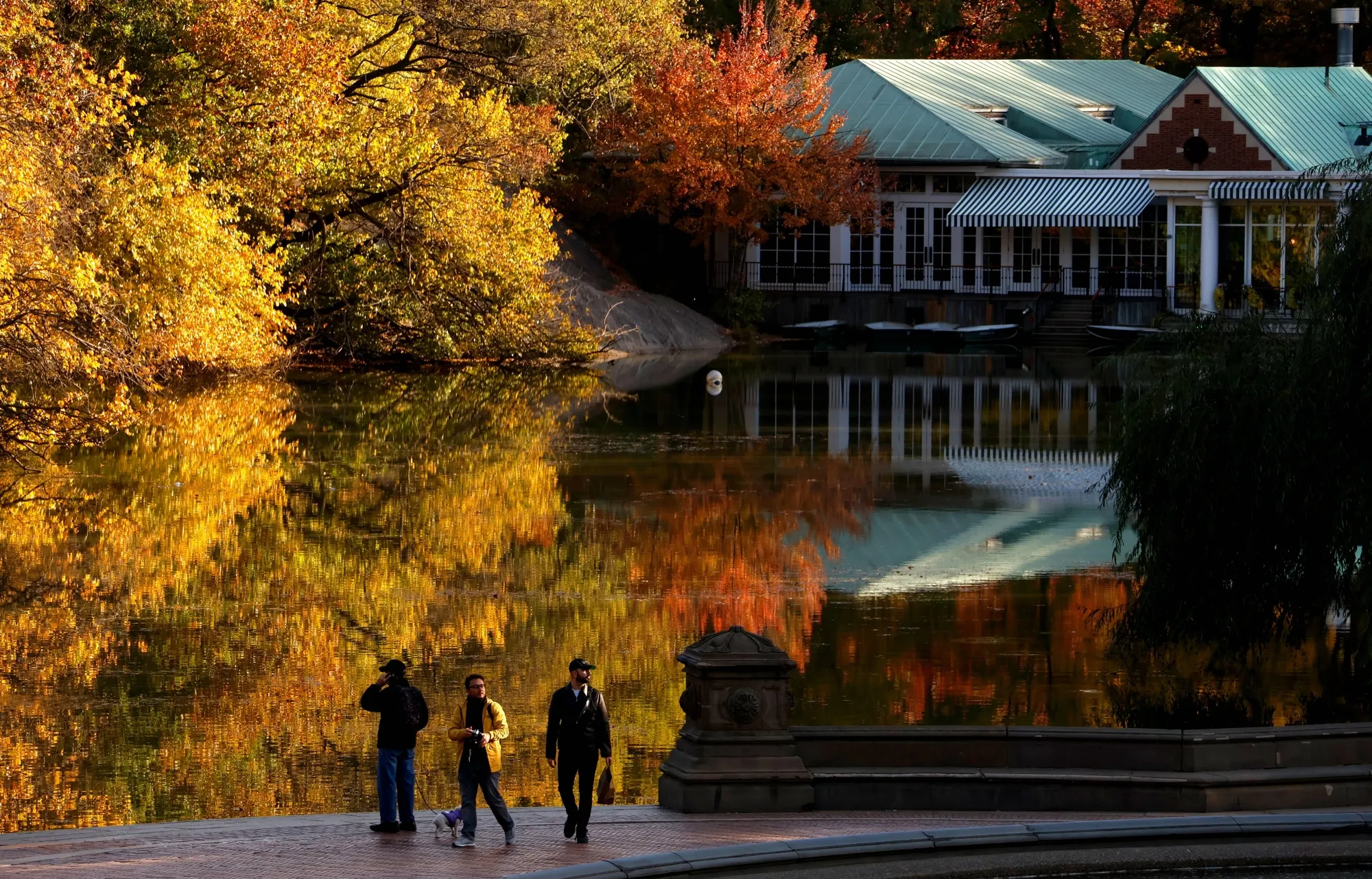 Visitors walk in front of trees turning color&nbsp;near the Central Park Boathouse&nbsp;on Oct.&nbsp;28.