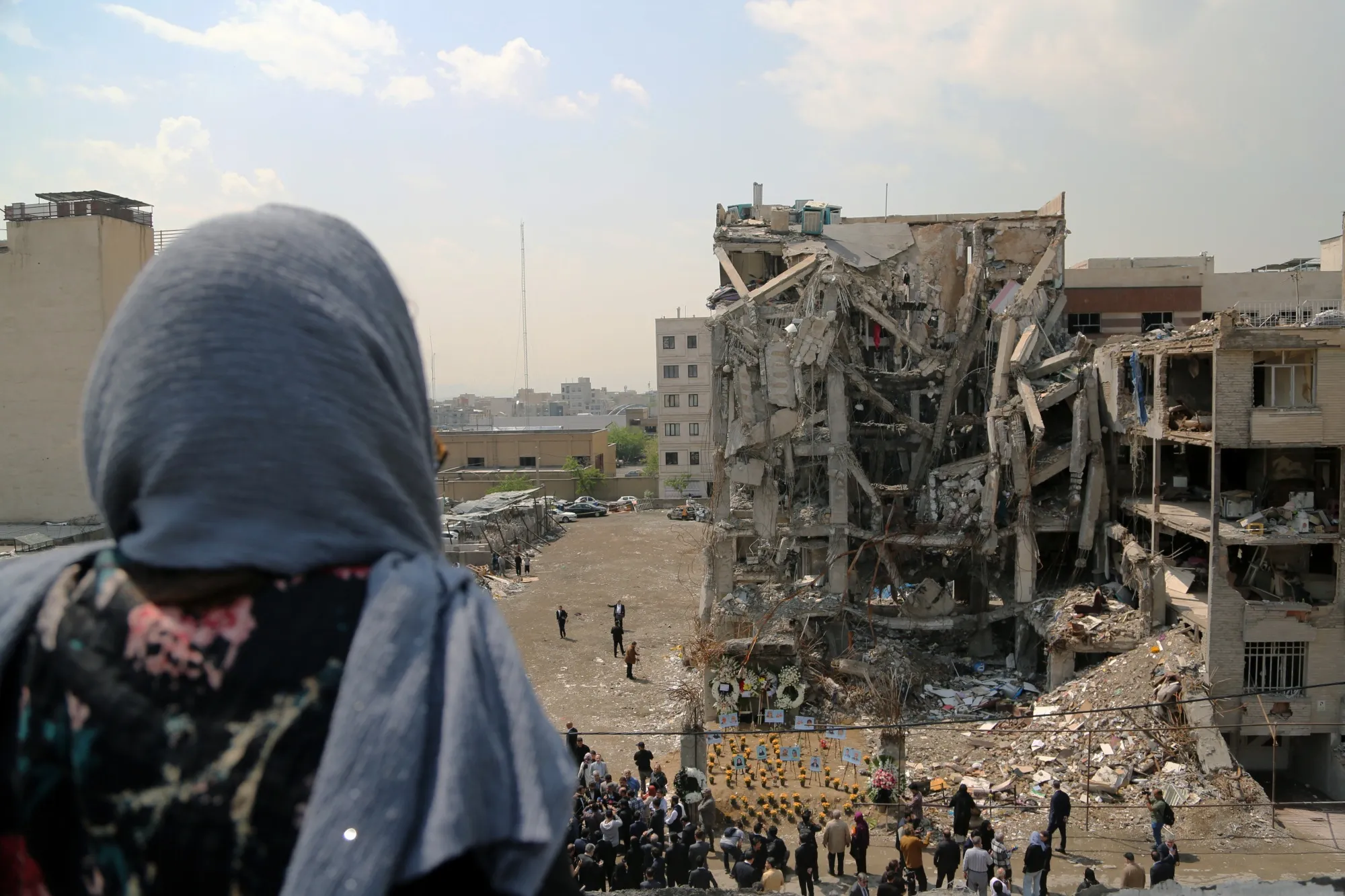 People visit the site of an airstrike in Resalat Square in Tehran on April 20.