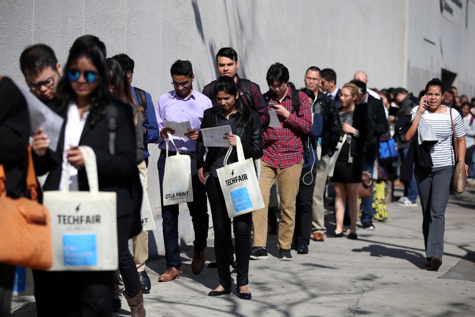 People wait in line to attend a technology job fair in Los Angeles in 2017.
