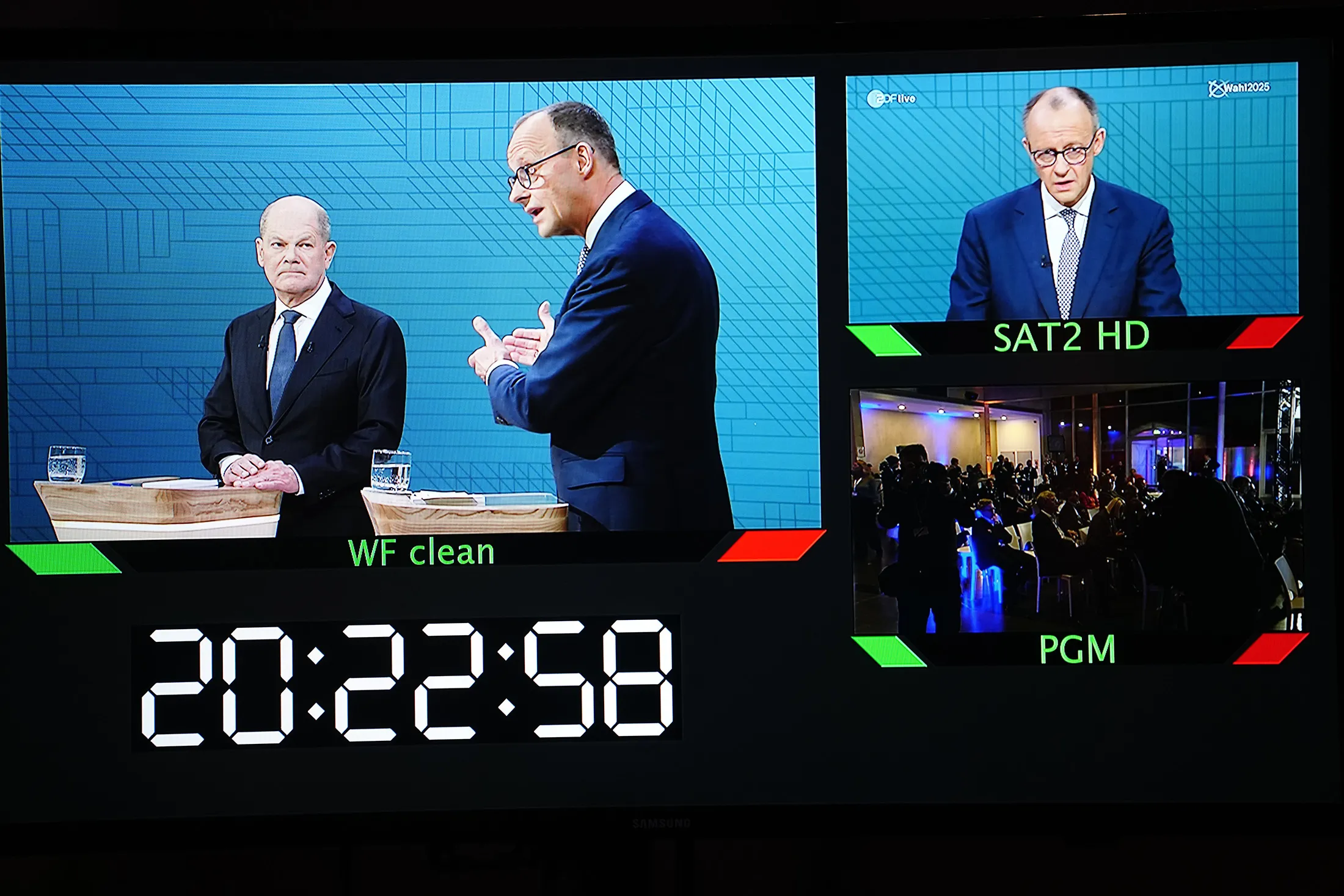 Journalists watch the televised debate between Olaf Scholz and Friedrich Merz in Berlin, on Feb. 9.