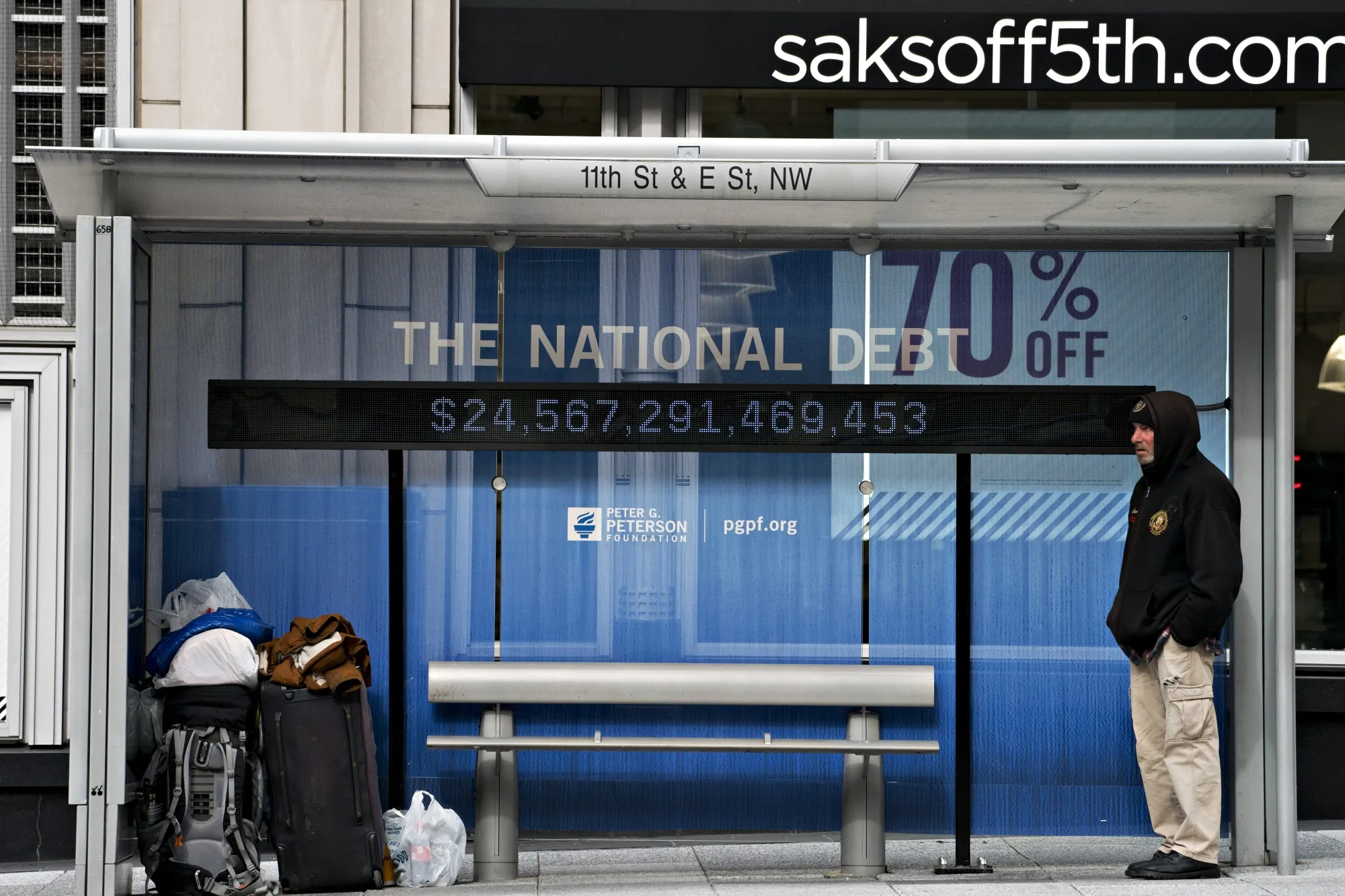 A national debt counter hangs inside a bus stop in Washington, D.C., U.S.