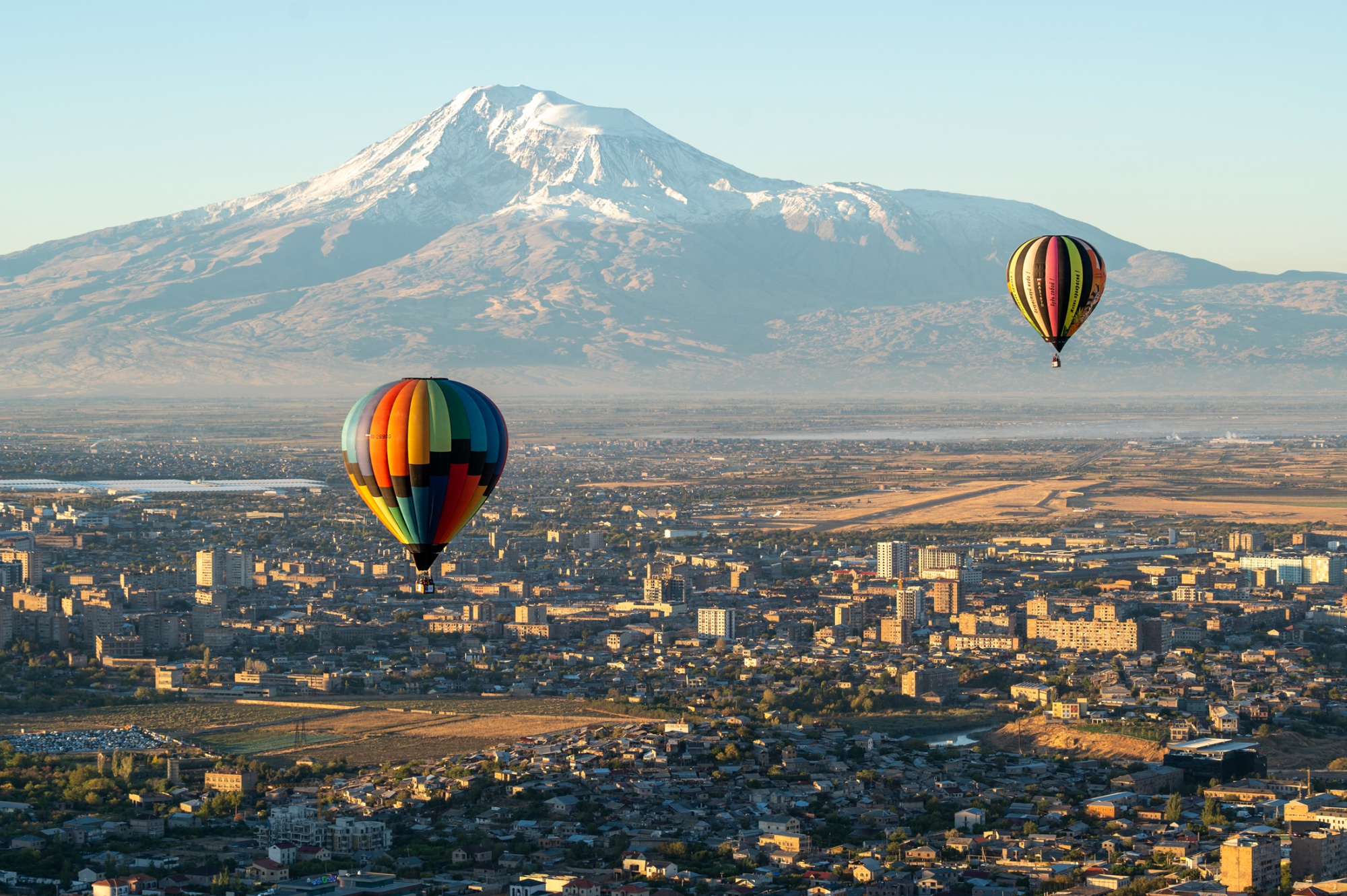 Hot air balloons over the Armenian capital of Yerevan, with Mount Ararat in the distance. Photographer: Karen Minasyan/AFP/Getty Images