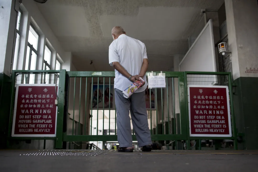 A man waits to board the&nbsp;Star Ferry.&nbsp;The Public Transport Fare Concession Scheme was launched in 2012.