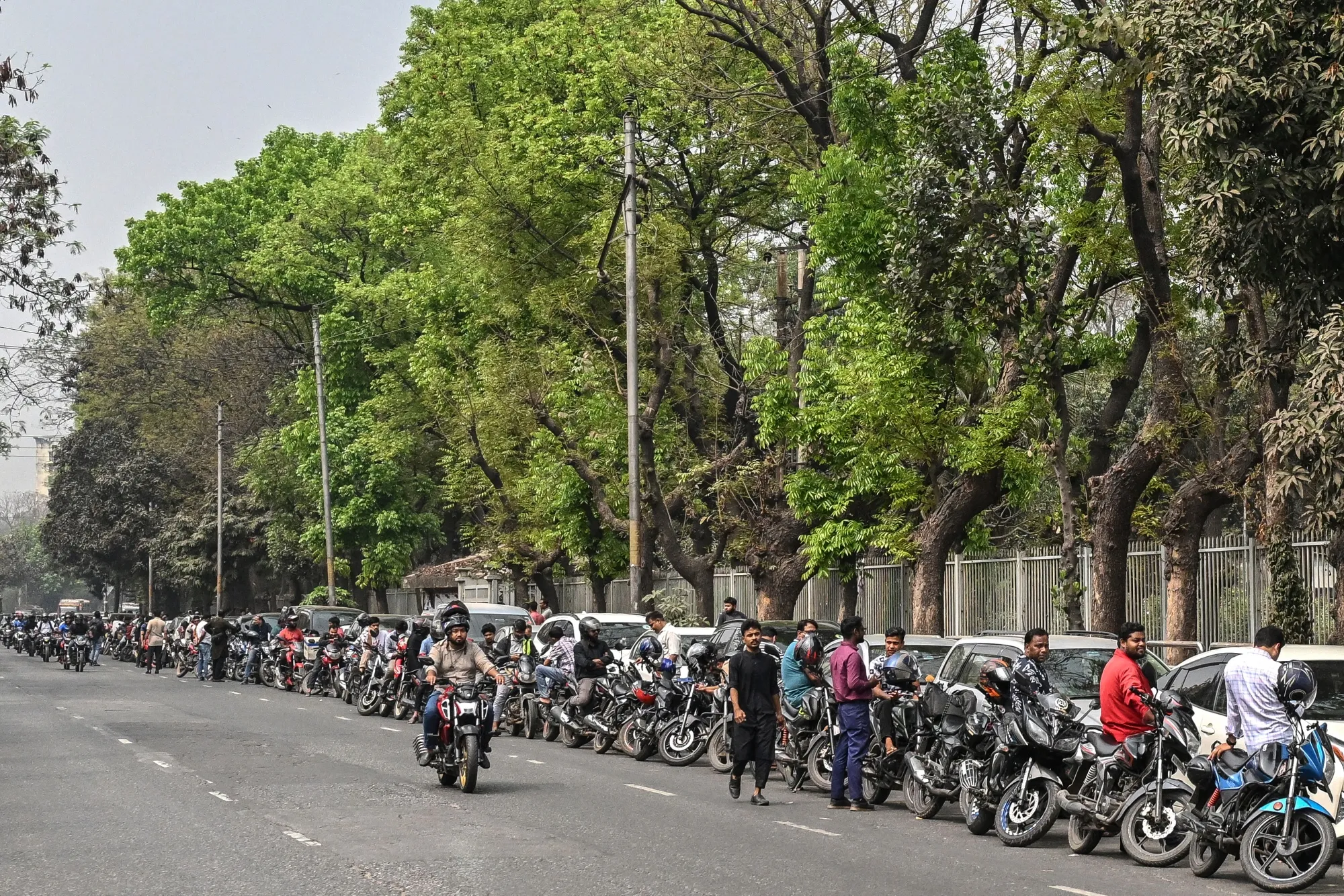 Motorists line up to refuel their vehicles near a fuel station in Dhaka, Bangladesh on March 8.