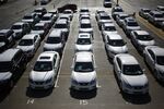 Vehicles sit parked outside the Nissan Motor o. manufacturing facility.