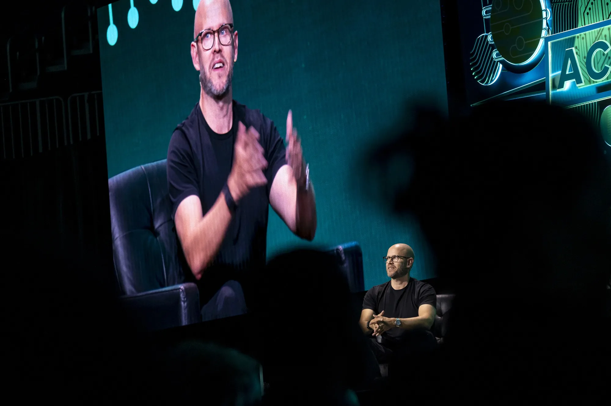 There’s only one Daniel Ek, pictured here on stage and on a giant screen at the Acquired LIVE event in San Francisco on Sept. 10, 2024. But his CEO role will be taken over by two people.