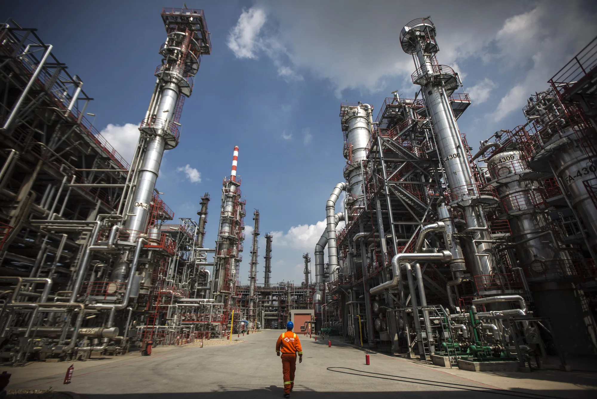 A worker walks through the refining complex at the Naftna Industrija Srbija AD (NIS) oil refinery, operated by OAO Gazprom Neft PJSC, in Pancevo, Serbia.