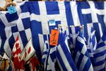 Greek national flags with a one euro price tag sit for sale at a Euro store in Athens, Greece.
