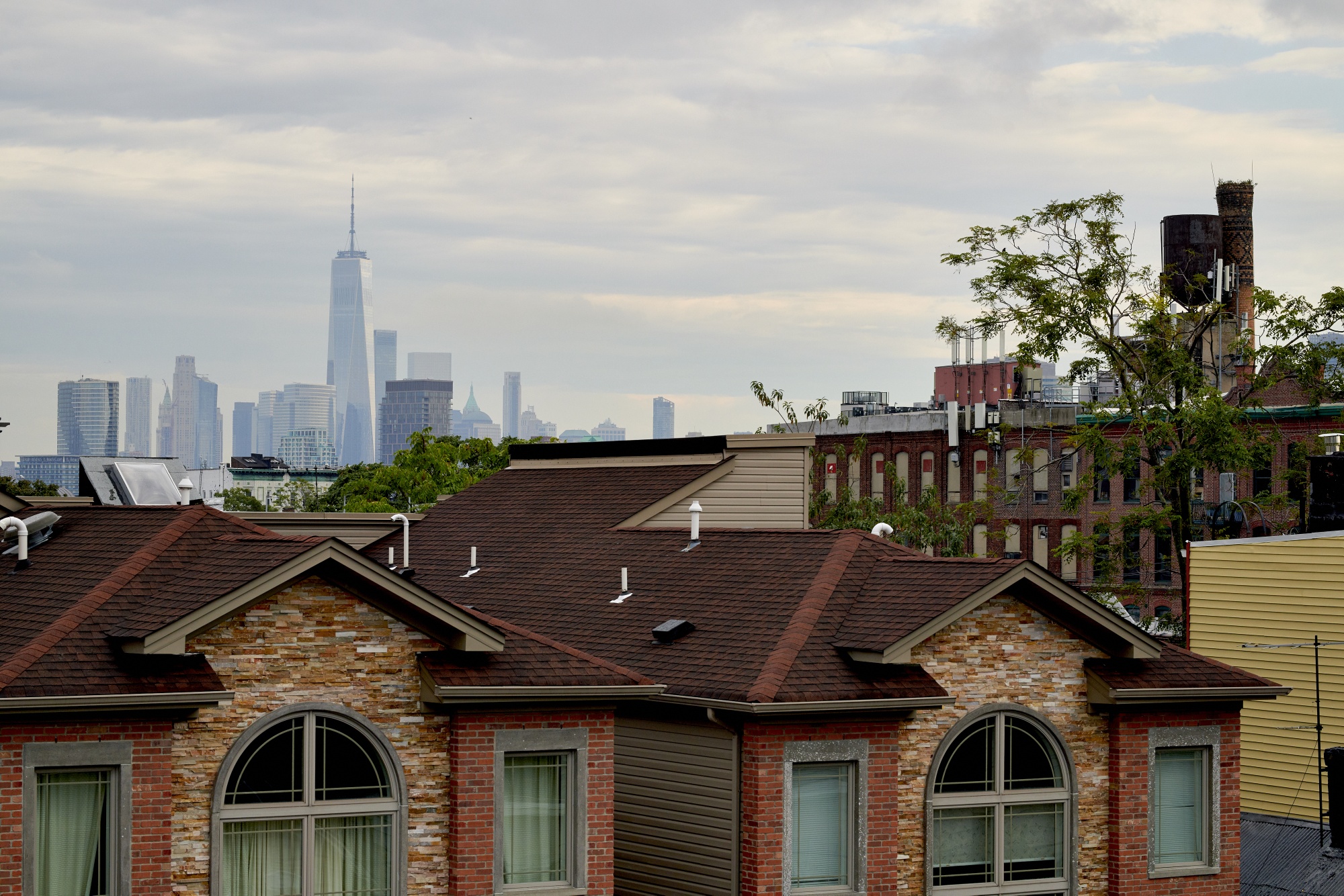 One World Trade Center building in front of residential homes in Jersey City, New Jersey, U.S.