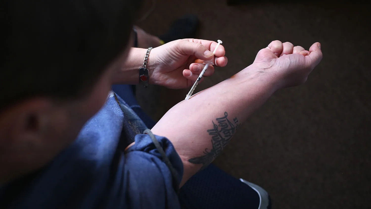 A heroin user injects himself on March 23, 2016, in New London, Connecticut.
