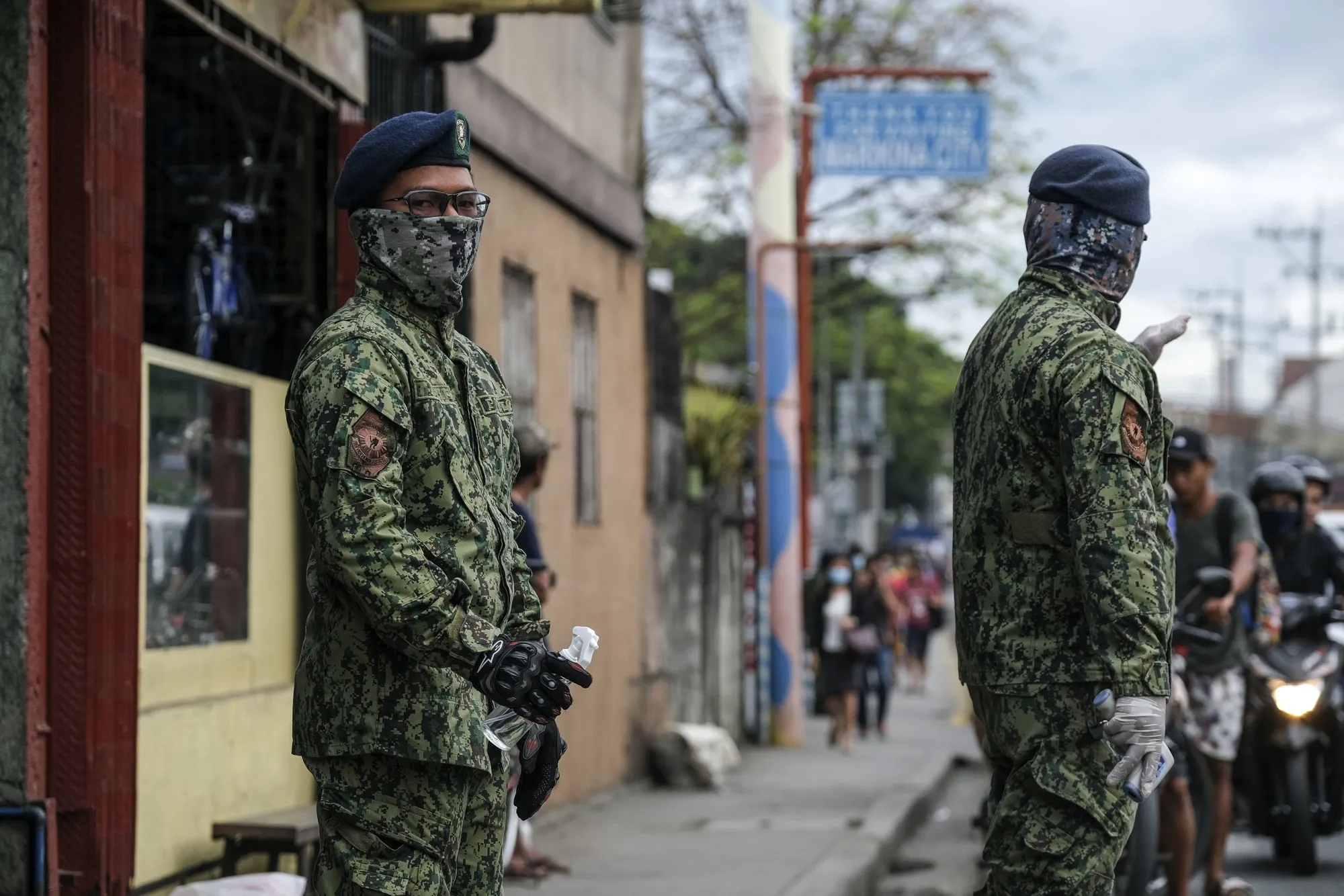 Members of the Philippine Army&nbsp;stand with disinfectant spray and a thermometer at a check point in the City of Marikina, Metro Manila, the Philippines, on March 16