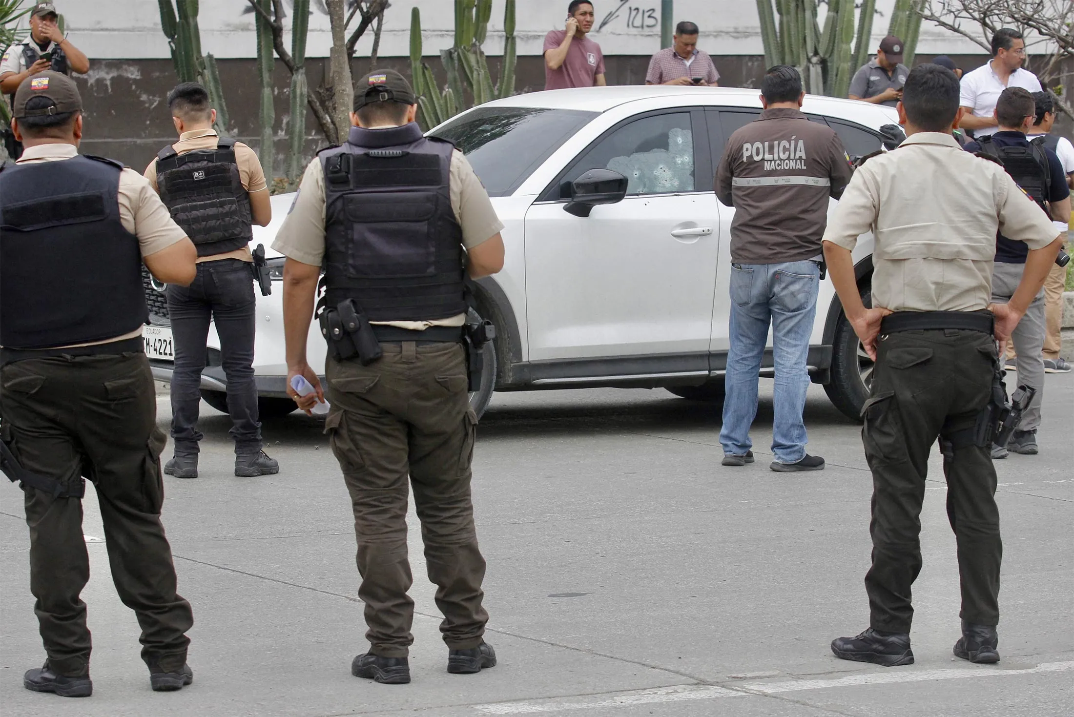 Members of the National Police inspect a car at the scene of the shooting in Guayaquil on Jan. 17.