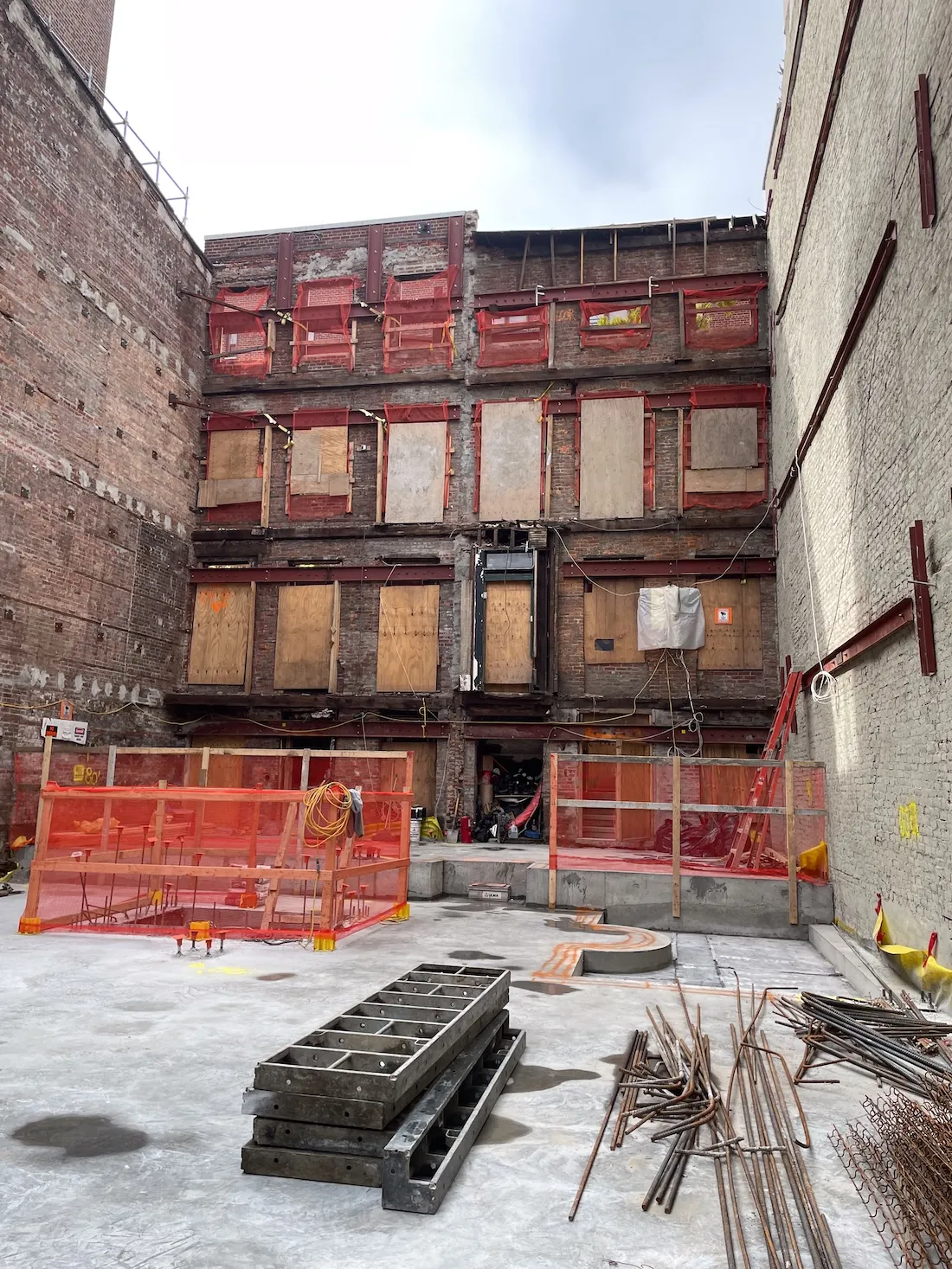 A construction site with the the facade of the building.
