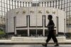 A pedestrian walks past the People's Bank of China (PBOC) headquarters in Beijing, China.