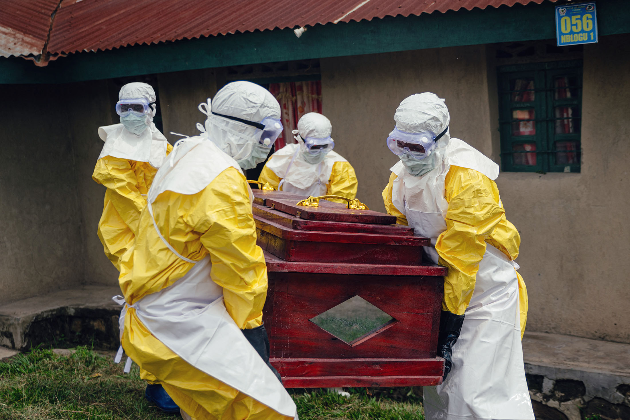 Red Cross members wearing personal protective equipment carry a coffin during a funeral in Bunia, Democratic Republic of Congo, on June 7. Photographer: Jospin Mwisha/AFP/Getty Images
