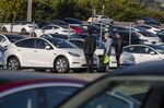 Customers at a Tesla dealership in Colma, California.