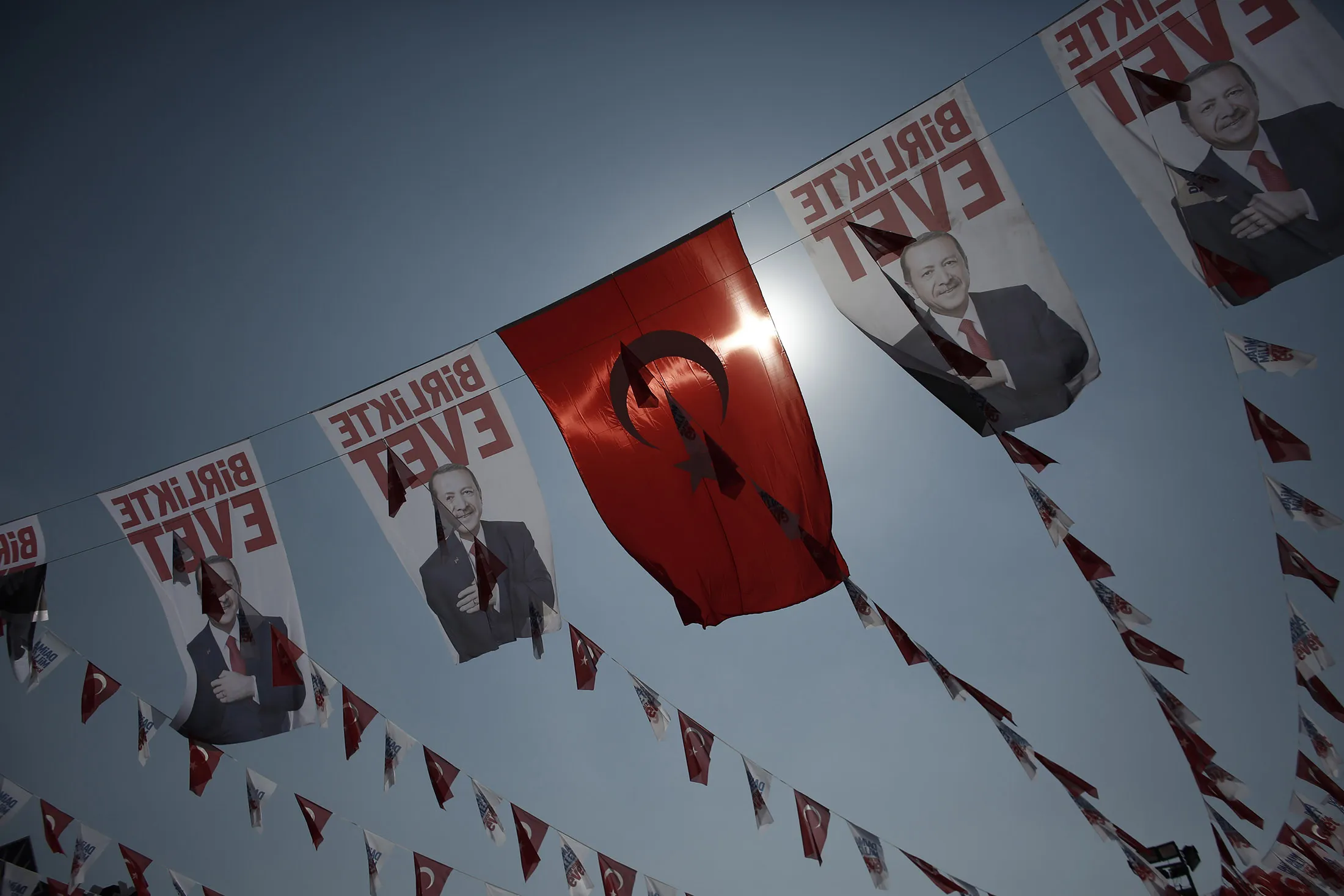 Flags decorated with the image of Recep Tayyip Erdogan, Turkey's president, and the Turkish national flag fly during a 'Yes' referendum campaign rally in Umraniye, Istanbul, Turkey, on April 15, 2017.
