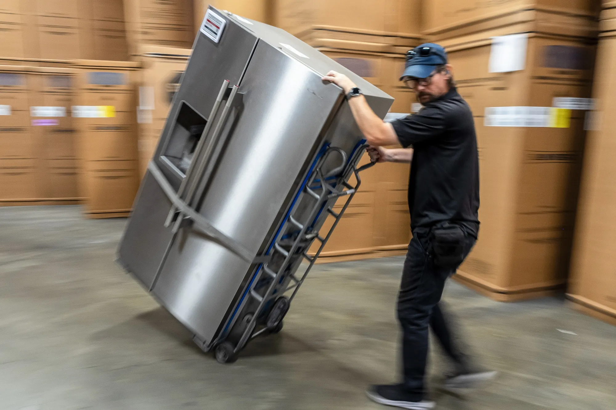 A worker moves a refrigerator at an appliance store in Santa Clara, California.