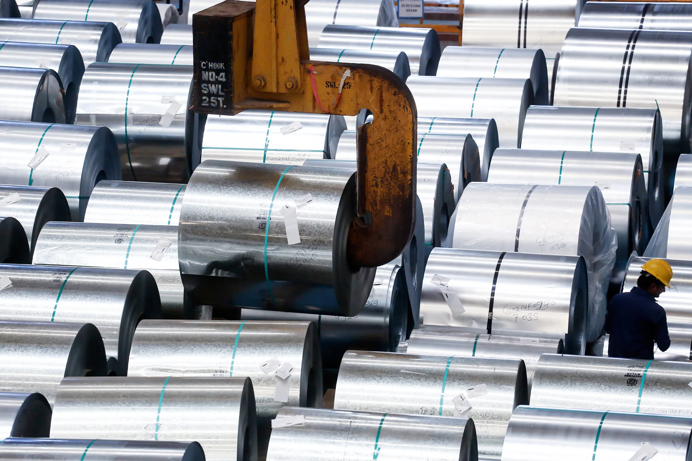An industrial crane lifts a coil of galvanised steel at the Uttam Galva Steels Ltd manufacturing facility in Khopoli, Maharashtra, India, on Friday, June 13, 2014. The rupee’s 4.4 percent rally in 2014 is the best in Asia and contrasts with a 3.1 percent slump in China’s yuan, the region’s worst performer. The currency’s strength is a concern for ArcelorMittal’s local unit Uttam Galva Steels Ltd., which competes with Chinese producers of the alloy.
