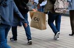 A shopper carrying a GU shopping bag in Kawasaki, Japan.