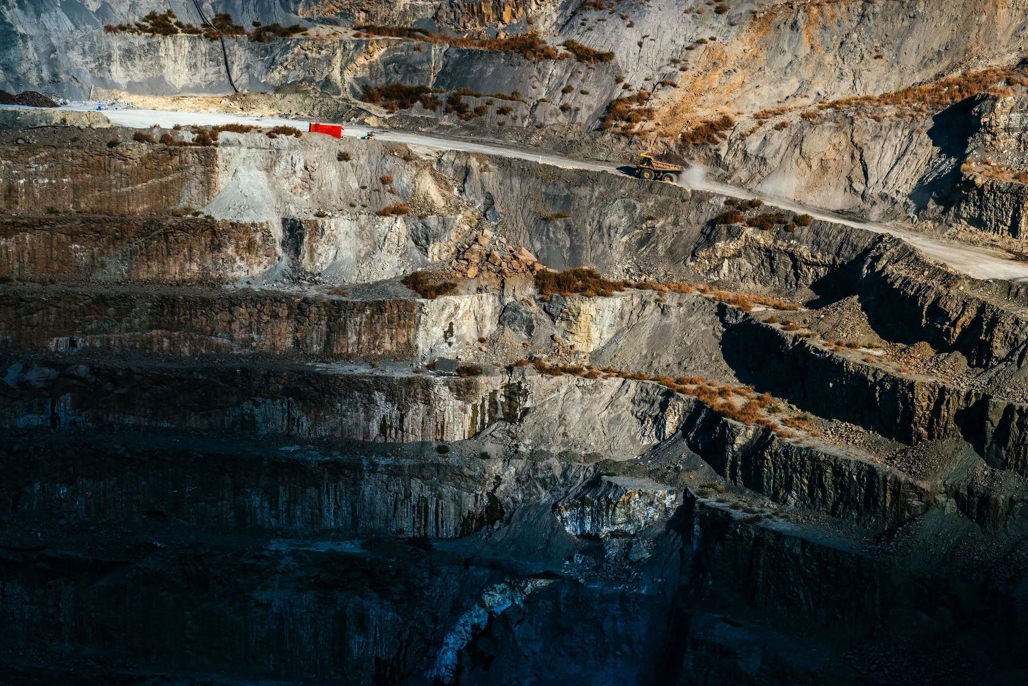 A truck carries newly excavated kimberlite rock out of the open pit at the Voorspoed diamond mine, operated by De Beers SA, in Kroonstad, South Africa, on Tuesday, May 3, 2017. The Anglo American Plc unit plans to store carbon-dioxide in kimberlite -- a type of ore best known for containing diamonds, but which also naturally reacts with carbon to remove it from the atmosphere.